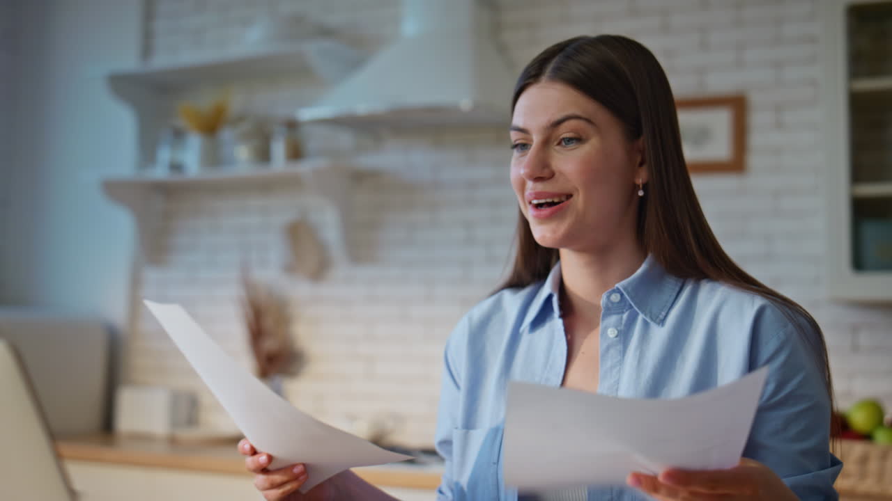 Joyful employee checking papers in home office closeup. Manager looking laptop