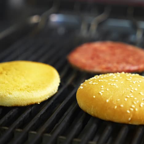 top view of the delicious burger cutlet and fresh buns grilled on barbeque. delicious dish freshly made on grid