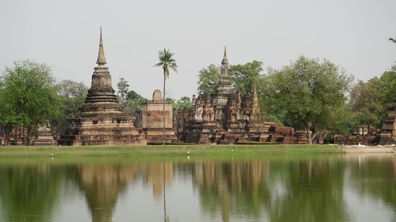 Ancient Buddhist Temples Reflected in Water at Sukhothai Historical Park, Thailand