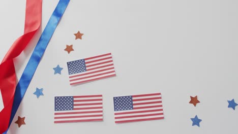 American-flags-with-red-and-blue-stars-lying-on-white-background