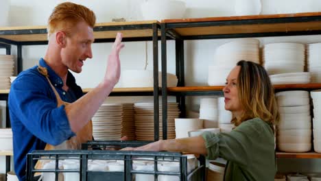 male and female potter giving high five to each other 4k