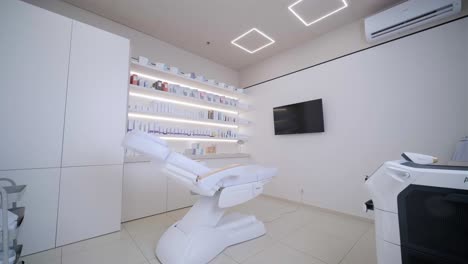 cosmetologist's empty office with care cosmetics and massage table in a modern beauty salon. medical cabinet interior. modernized cosmetic center for health care. blurred background.