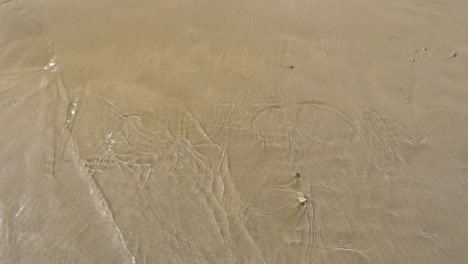 Meereswelle-Wäscht-London-Auf-Den-Sand-Geschrieben