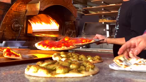 manakeesh lebanese breakfast putting into the hot flaming oven