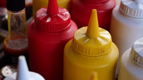 closeup of ketchup, mustard and mayonnaise bottles