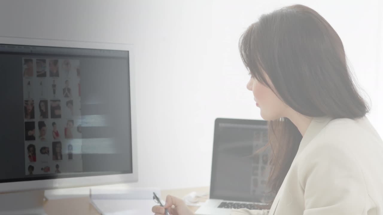 Animation of caucasian businesswoman using computer over cityscape