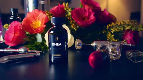 dhea supplement displayed with flowers and beauty accessories