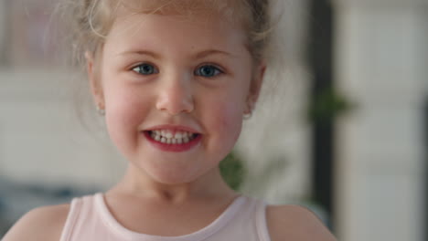 portrait happy little girl smiling with playful excitement looking at camera enjoying fun childhood 4k