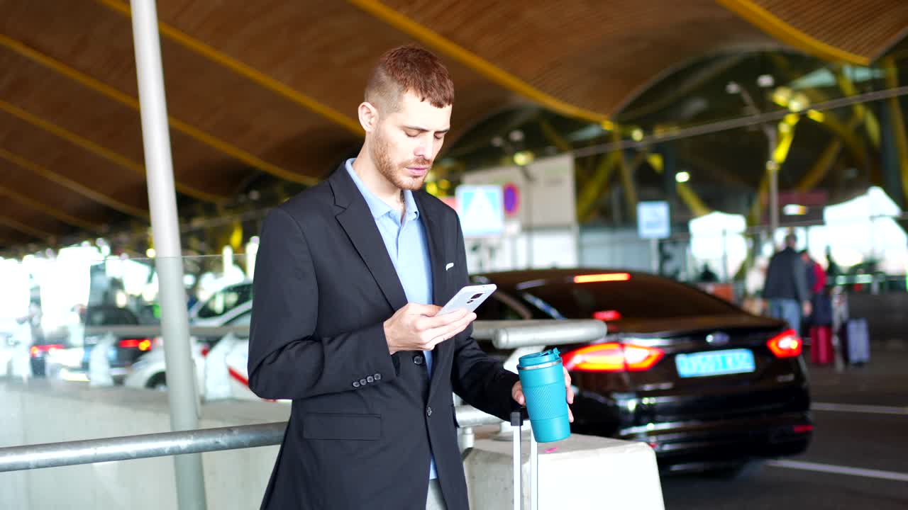 Man talking on phone near airport transportation