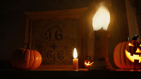 spooky halloween decor with pumpkins and candles