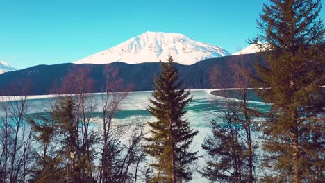 4K-Drone-Video-of-Snow-Covered-Lakeside-Mountains-in-Alaska-During-Winter