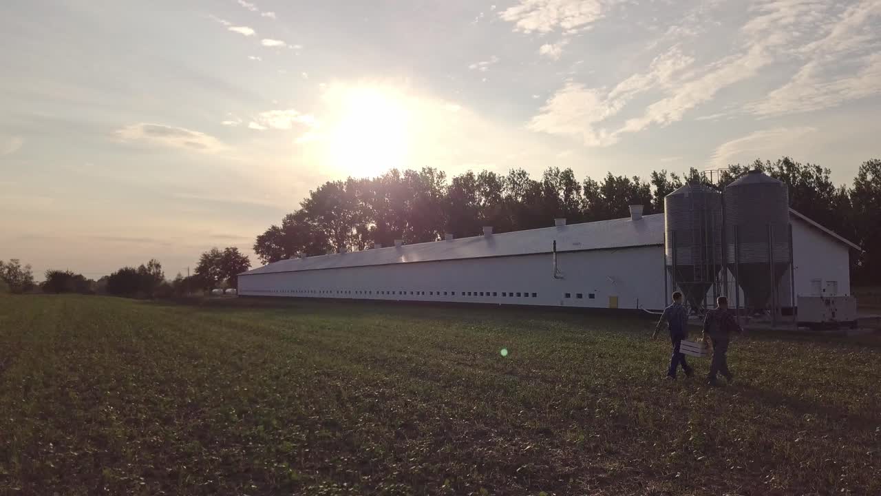 Aerial view of farmers walking across the field