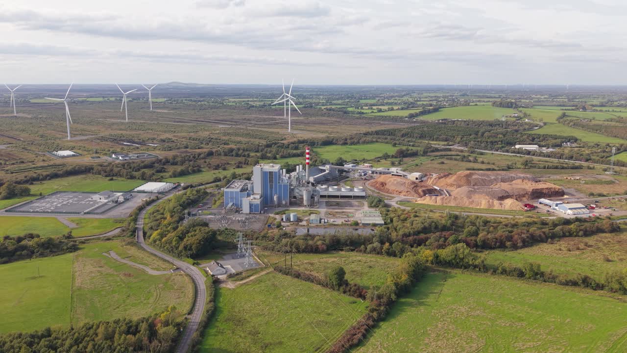 Edenderry Biomass Power Station with Wind Turbines in the Background in Ireland