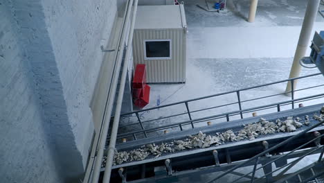 metal constructions and equipment at industrial plant. conveyor lines delivering rocks of white clay.