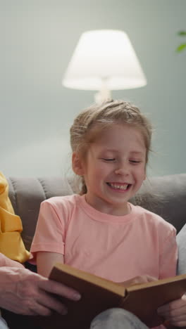 girl reads funny stories for the old lady and they rejoice and laugh together with their grandma, a cozy home atmosphere