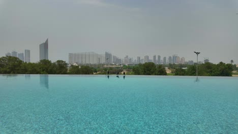 dubai hyperlapse of vida hills pool with skyscrapers and trees