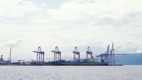 unloading cargo ship. harbor crane.