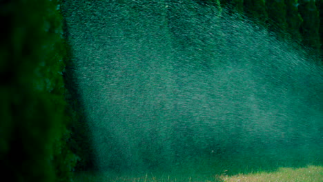 a sprinkler is working in a park or garden