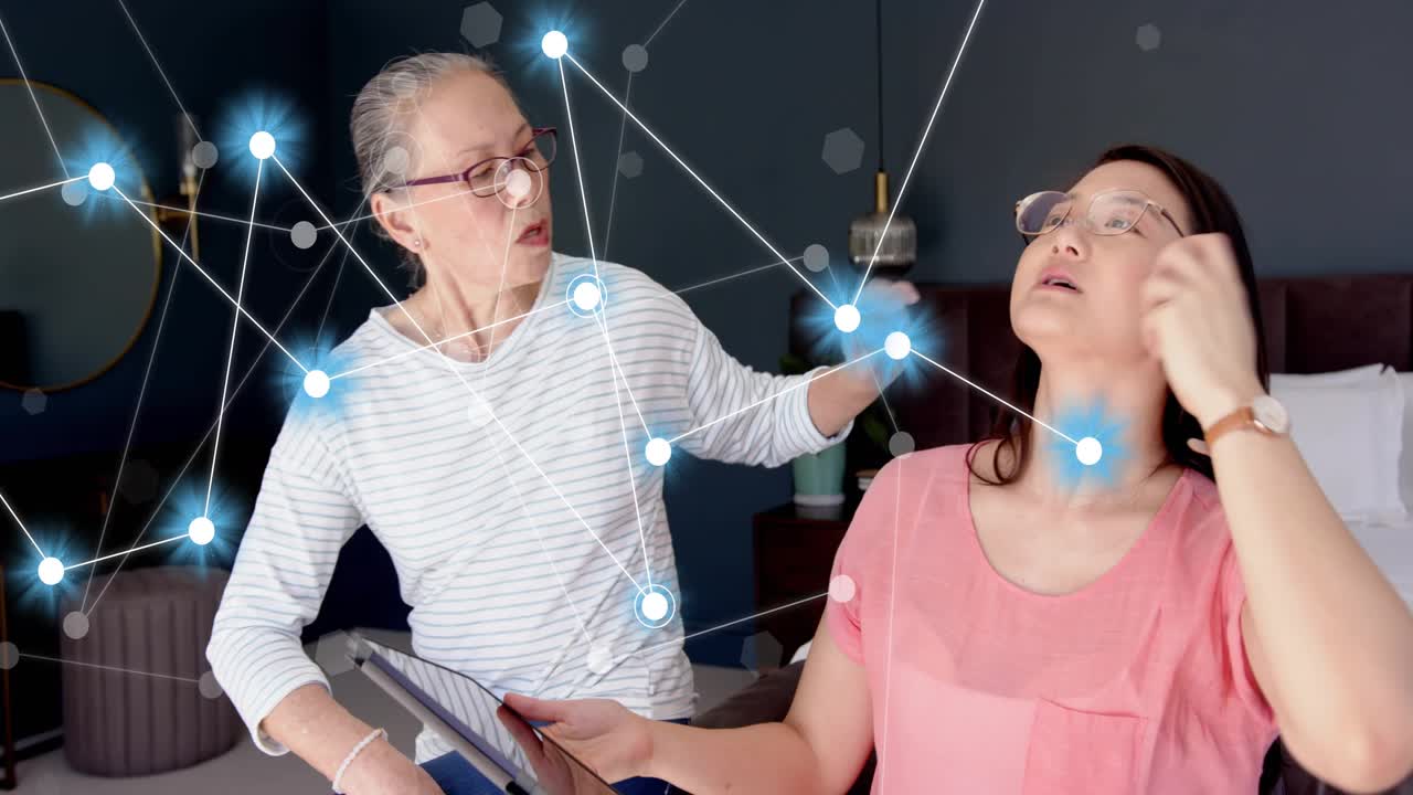 Mother pointing comforting daughter on bed while rotating tablet revealing network for health