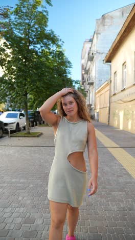 woman walking down a city street in summer