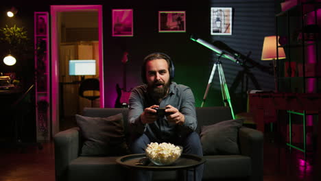 excited man playing videogames using controller, having fun