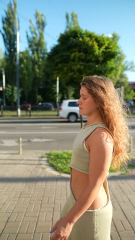 woman in a green dress on a city street