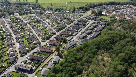 aerial view of rows of neatly ordered houses in green suburban area