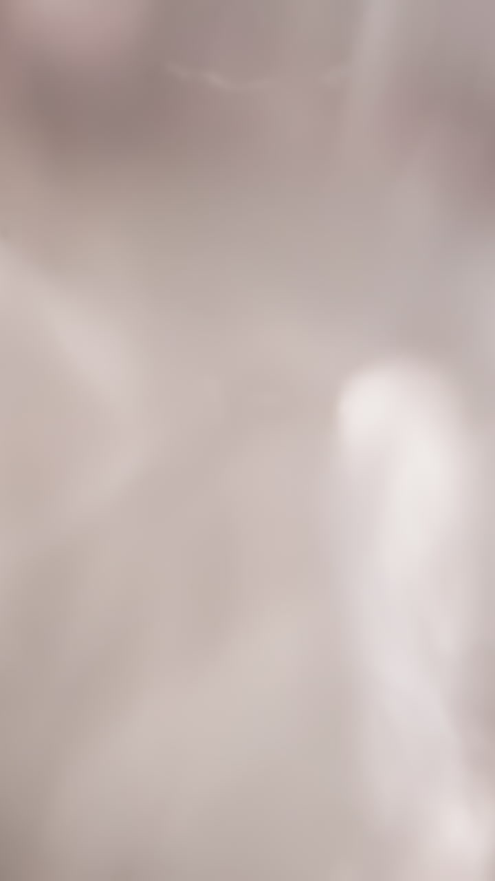 Water vortex with bubbles in round container. Mixing tasteful beverage for uniform dissolution of components and enrichment with oxygen. View from bottle bottom macro