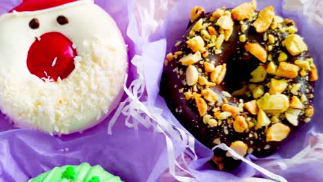 unpacking a christmas donut box, donuts with icing and sprinkles