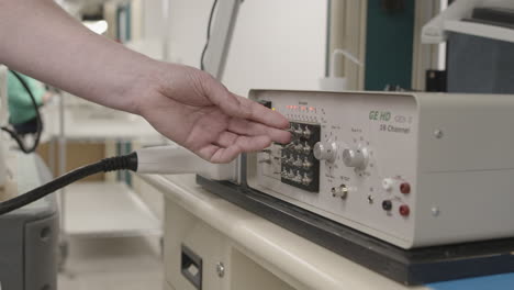 technician flipping toggle switches to test electrical equipment in a factory slow motion