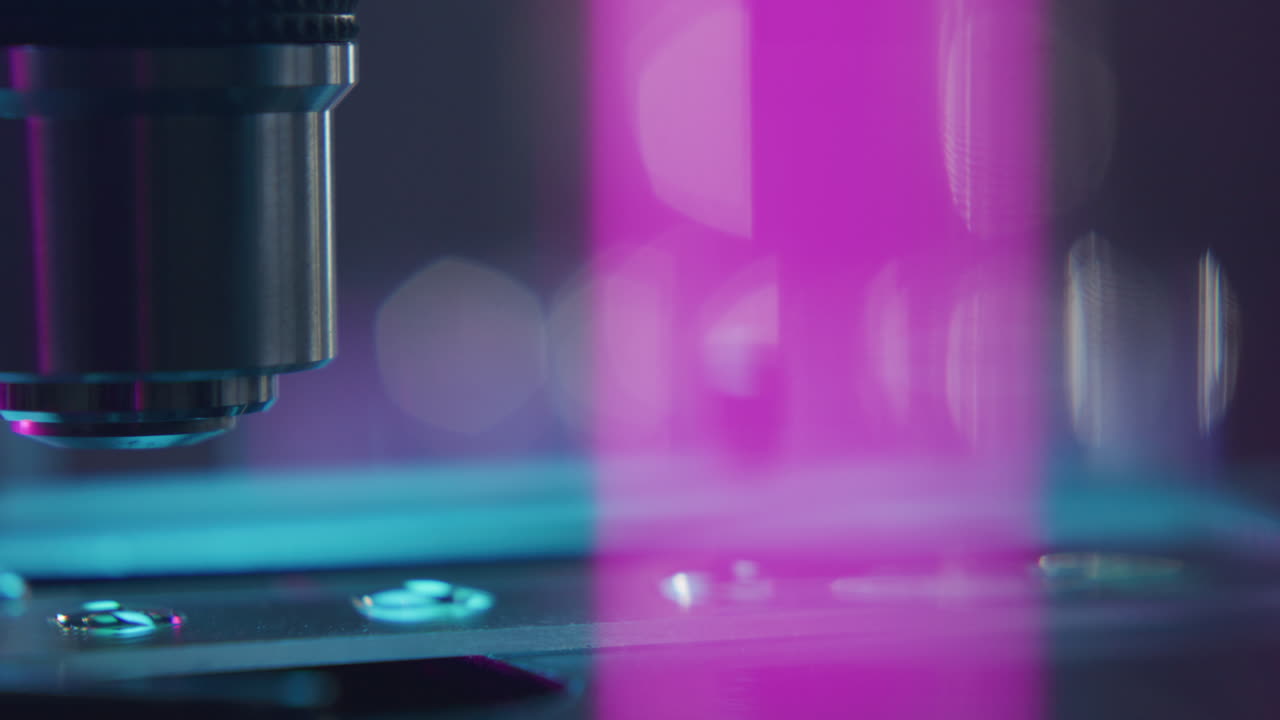 Microscope Objective Lens Hovering over Slide during Sample Examination