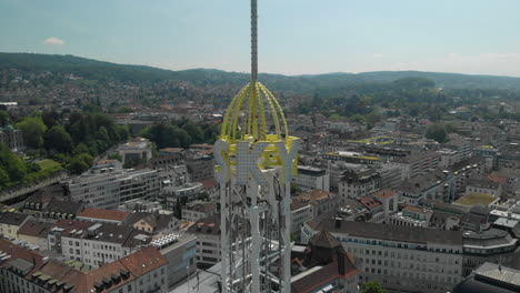 close aerial drone shot orbiting around amusement park free fall tower in zürich, switzerland during zürichfest