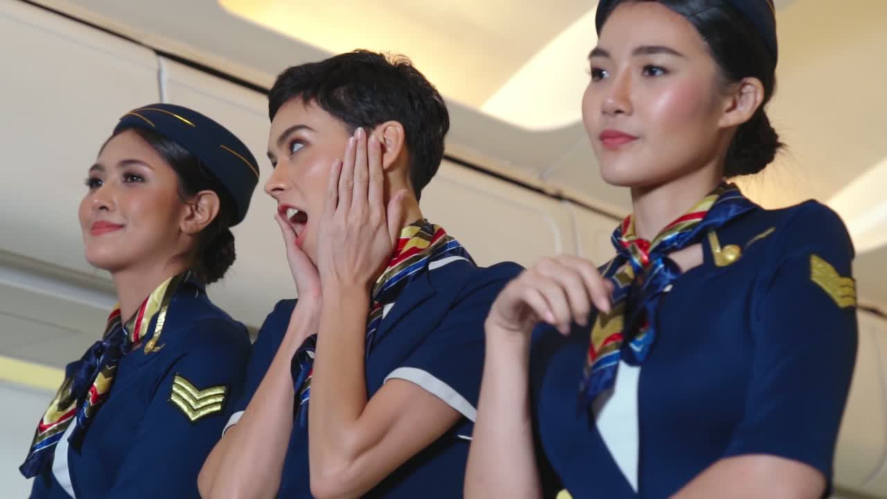 Premium stock video - Cabin crew dancing with joy in airplane