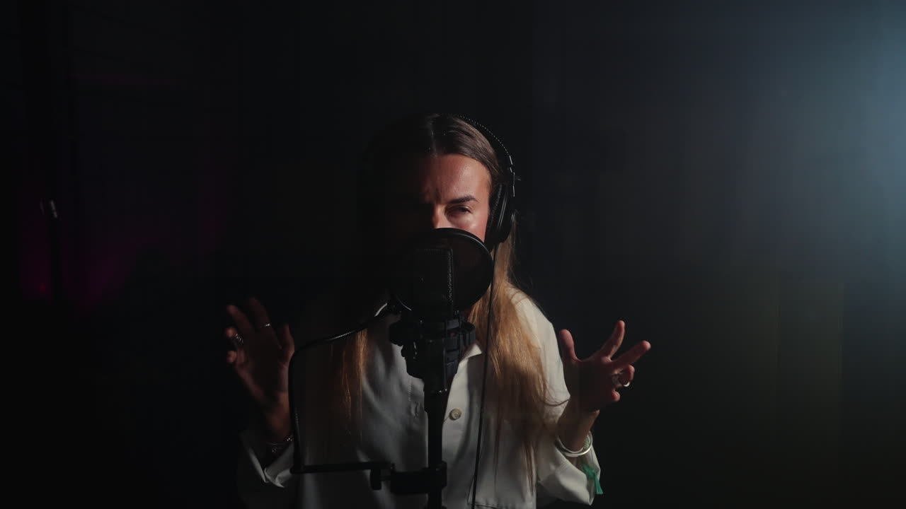 녹음 스튜디오 에서 마이크 로 노래 하는 여자