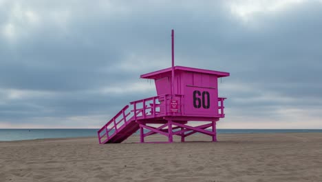 pink lifeguard tower 60 on the beach on a cloudy day