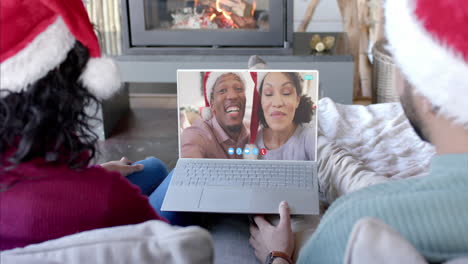 two happy diverse couples having christmas laptop video call, slow motion