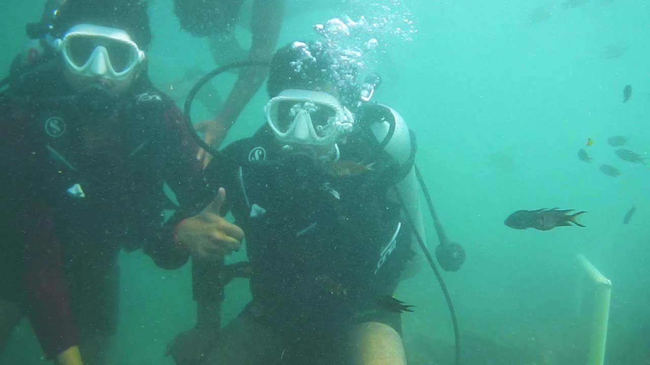 un chico disfrutando de la experiencia de buceo bajo el agua en un mar azul profundo
