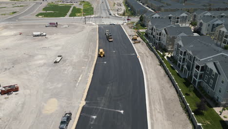 suburban utah roadwork development aerial view rising above new build real estate asphalt road construction