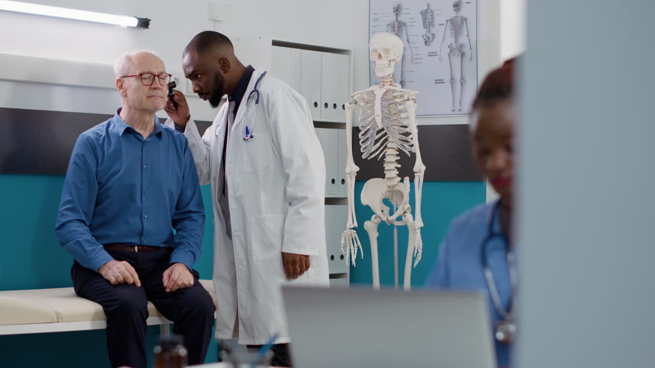 Doctor examining elderly patient in clinic