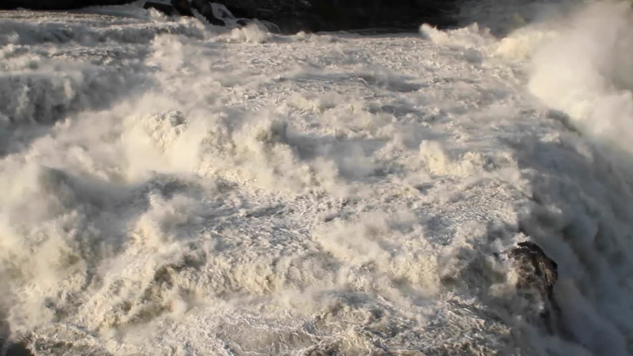 Water flowing over the waterfall crest