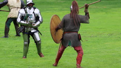 intense reenactment duel between saxon warrior and english knight at arundel castle: spear throw and sword clash to the finish