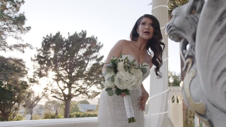 Cinematic shot of bride posing as she is photographed on her wedding day