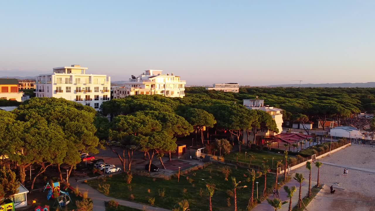 Aerial view of scenic albanian landscape with hotel buildings in front of the beach.