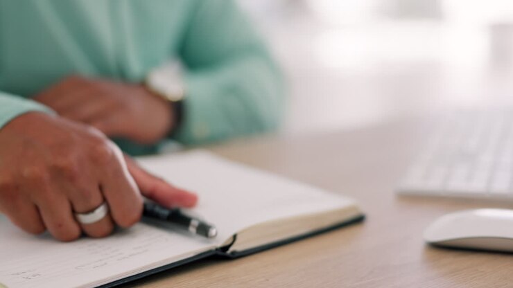 Closeup, hands and notebook for planning