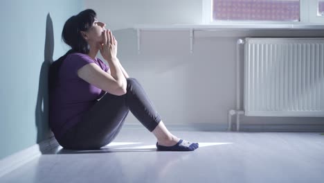 depressed woman covering her face with her hand.
