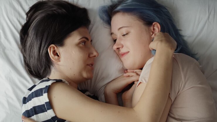 Top view video of lesbian couple together in bed.