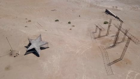 drone flying over bombay beach california, desert art