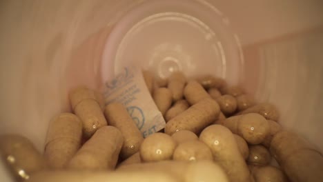 quickly moving out of the entire length of a supplement pill bottle with desiccant still in