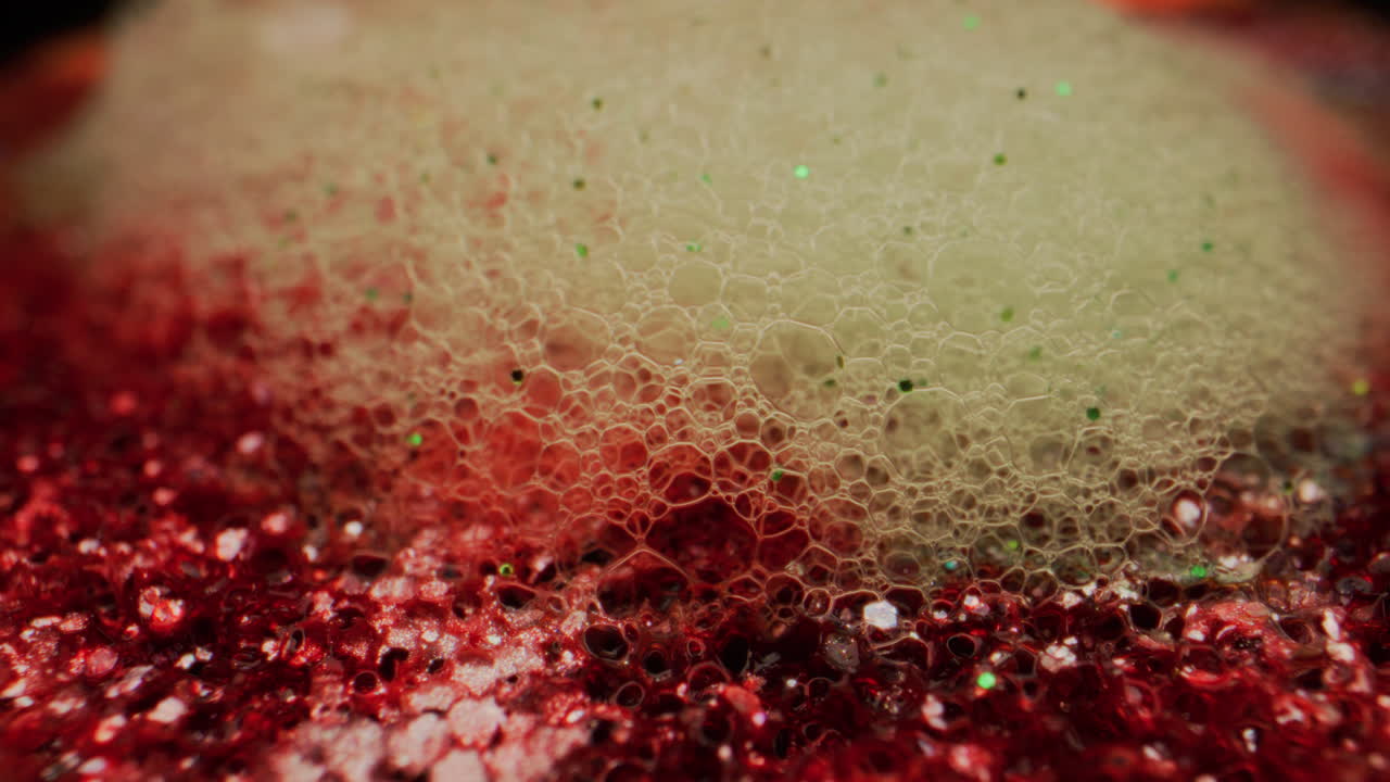 Macro Shot of Bubbles and Glitter on a Red Surface