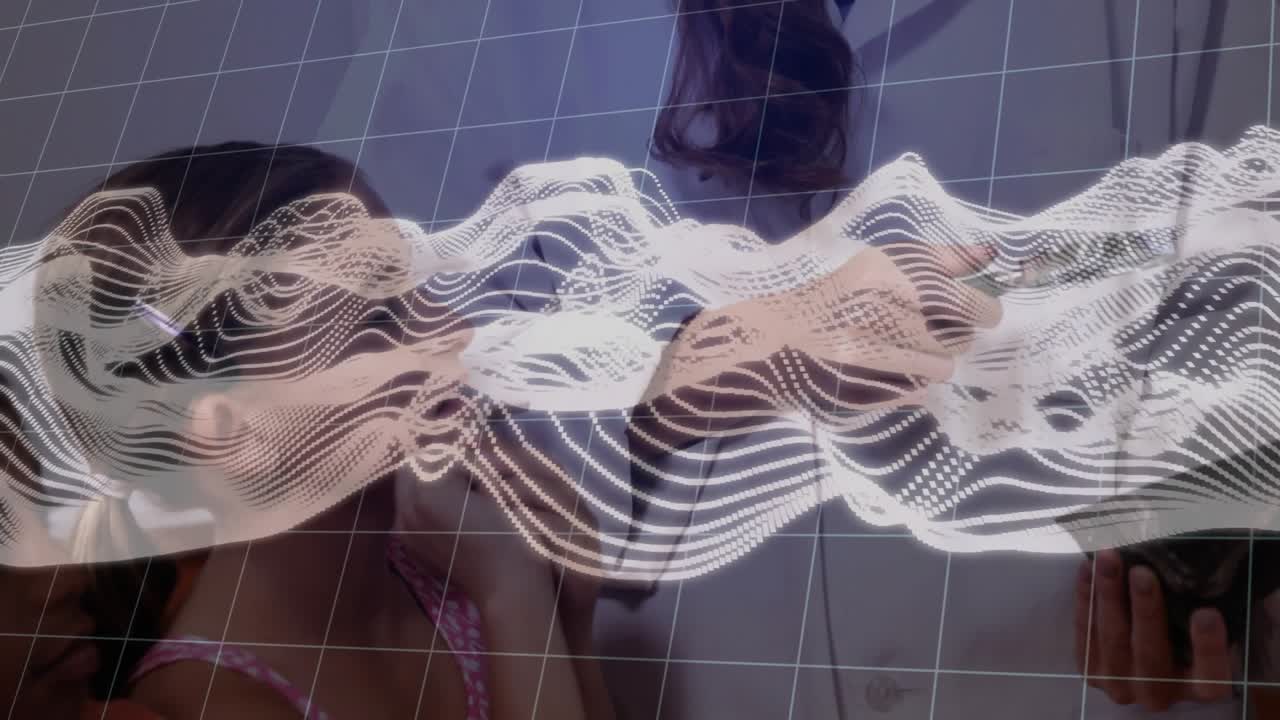 Teenager holding specimen triggers 3D grid with waveform scan while guiding student through lab